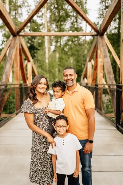 Family of four on a wooden bridge